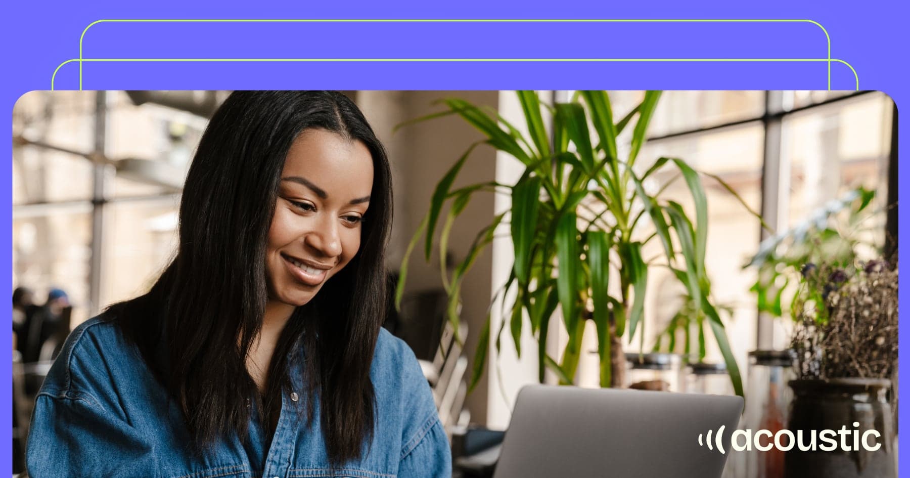Woman reading MarTech content on laptop in modern office with plants - Acoustic