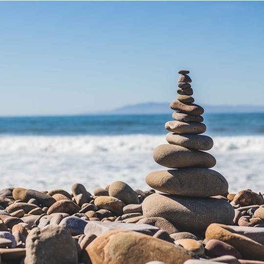 Stones stacked on top of each other on a rocky beach.