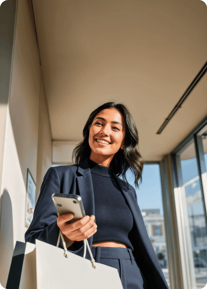 Retail shopper smiling at her phone while out shopping