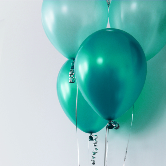 A bundle of teal-colored balloons. 