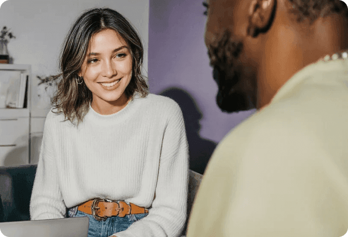 Two professionals working together on a laptop