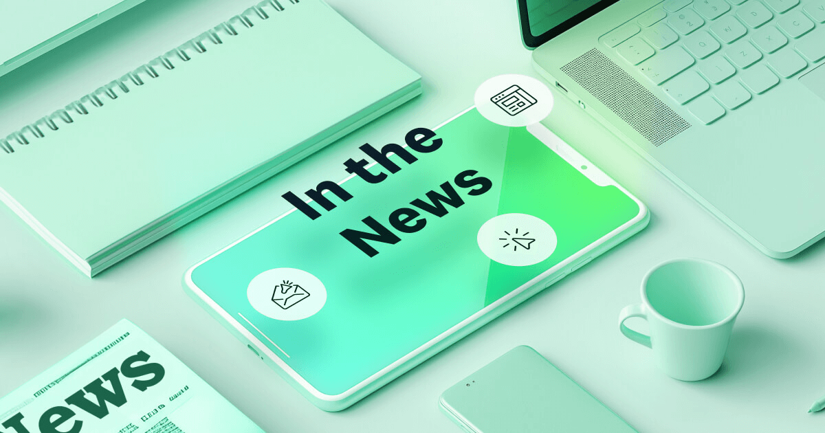 Text reads "In the News" over a blue, green, and yellow gradient background. Icons of a light gray newspaper and magnifying glass are also pictured.