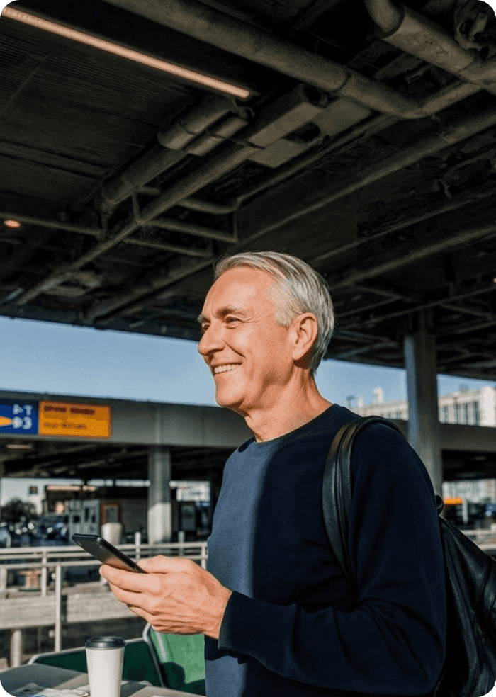 Travel guest checking his phone in an airport lounge