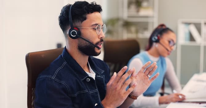 Support specialists wearing headsets at their workstations