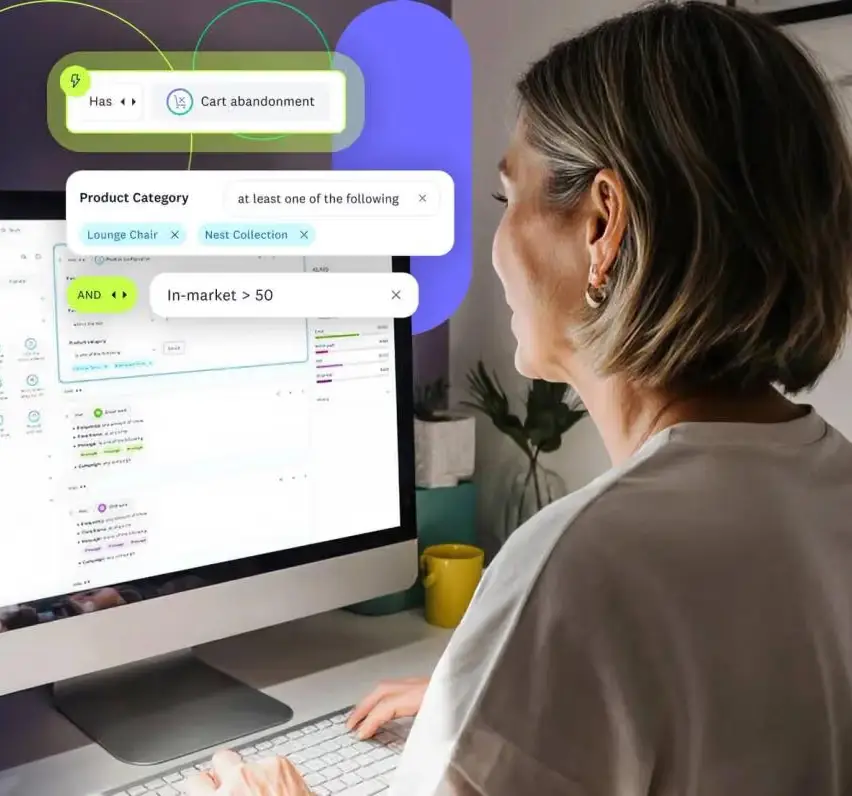 A person viewing the Acoustic segment-builder UI on a desktop monitor, showing cart abandonment and in-market interest rule conditions.