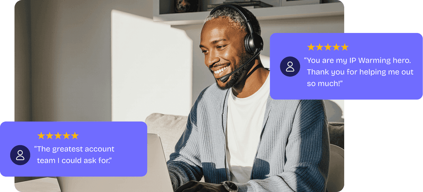 Man in a headset smiling at his workstation, beside five-star feedback cards